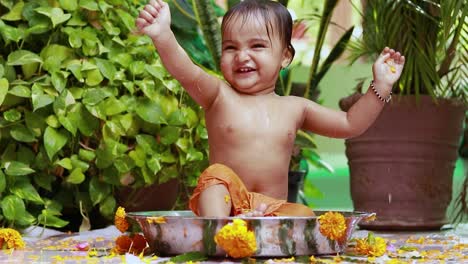 cute toddler baby boy bathing in decorated bathtub at outdoor from unique perspective