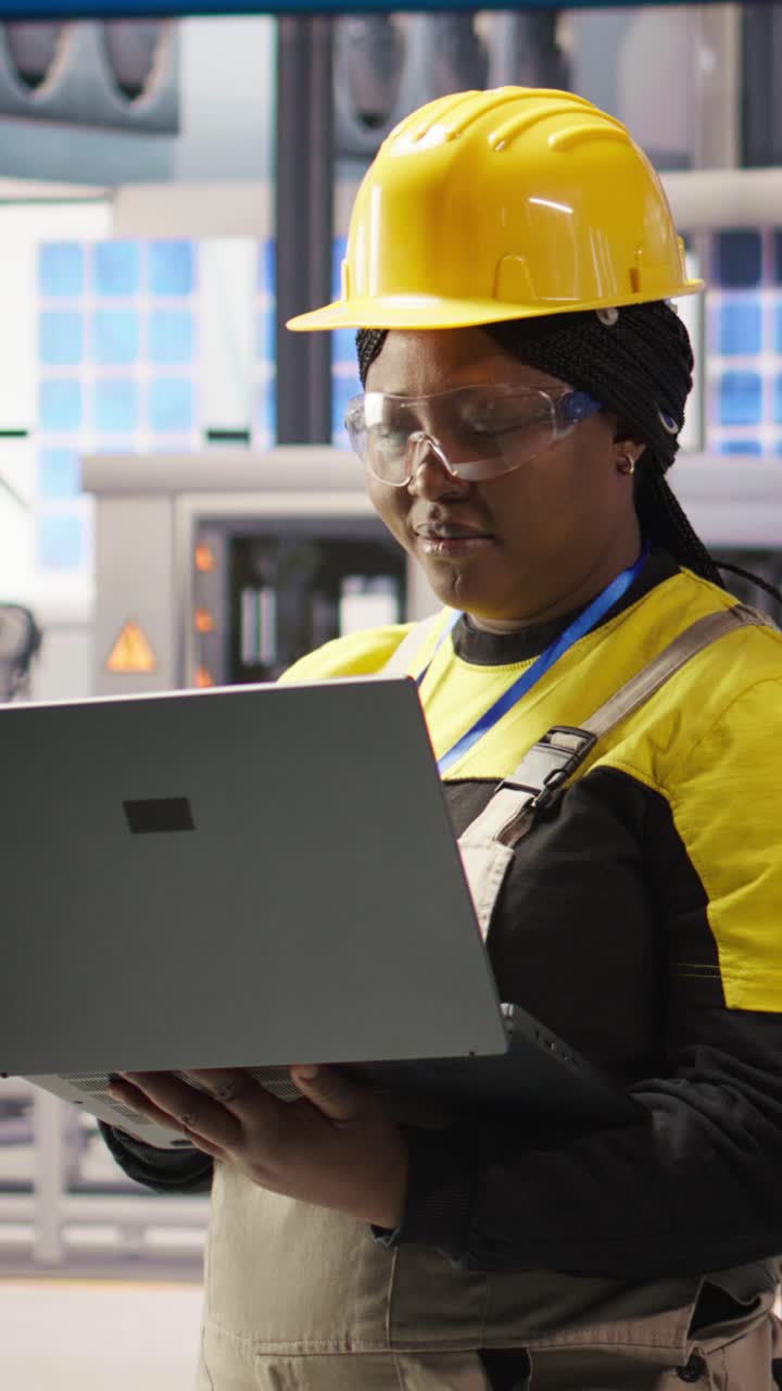 Vertical video Engineer does predictive maintenance using laptop, analyzing IoT sensor data