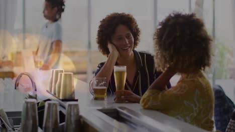 animation of light spots over happy diverse friends drinking beer