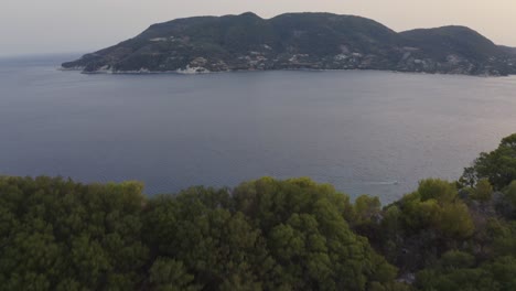 Aerial---Reveal-of-the-ocean-behind-Marathonisi,-Zakynthos,-Greece