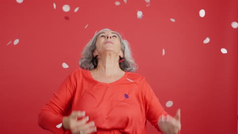 Happy Senior Woman Celebrating with Confetti