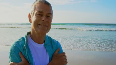 Front-view-of-active-senior-Caucasian-man-standing-on-the-beach-4k