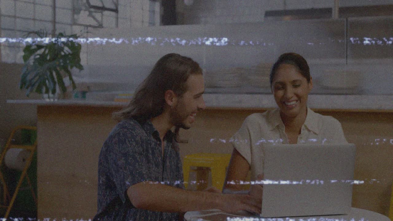 Animation of screen with glitch over diverse female and male coworkers in office