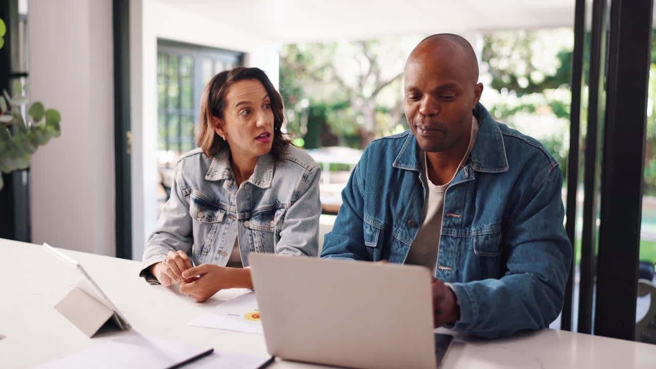 Couple working on laptop at home