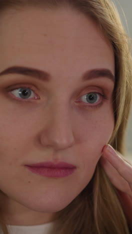 surprised and disappointed woman watches breaking news in apartment closeup slow motion. lady shock of unexpected information. woman portrait