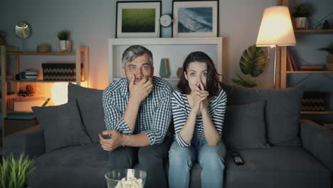 couple watching a tv at night
