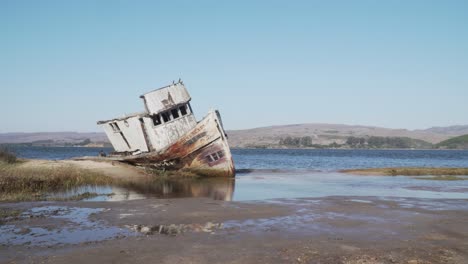 Static-Shot-of-Beached-Shipwreck-Near-the-Bay