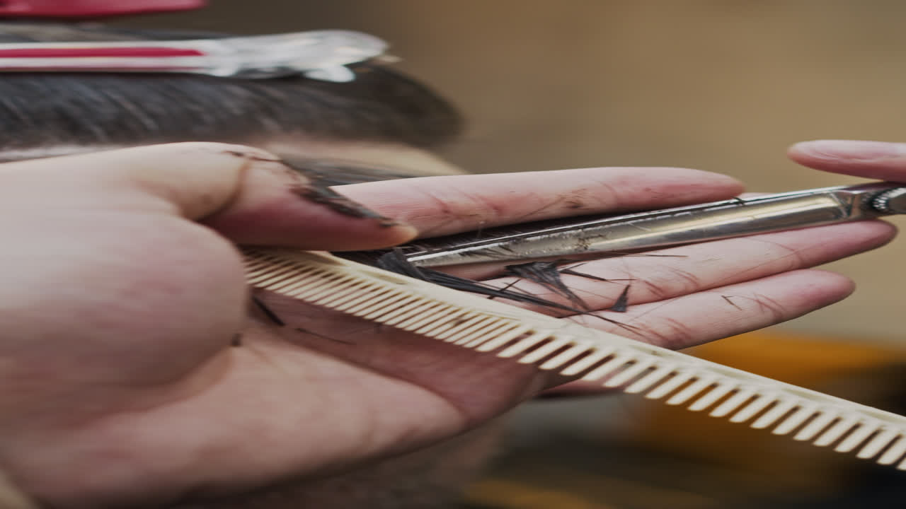 Hands of Barber Trimming Mans Hair at Salon