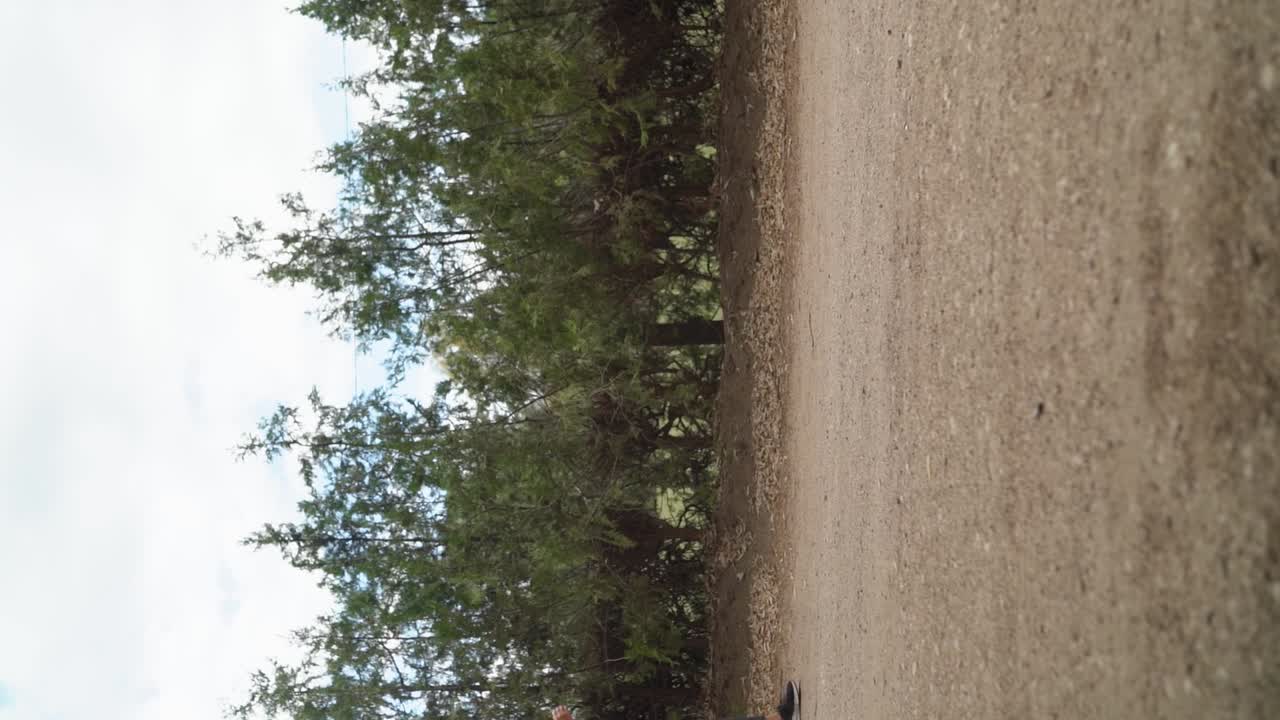 A Lady is Power Walking Outdoors - Vertical Shot, Slow Motion