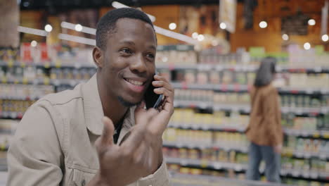 man talking on phone in grocery store