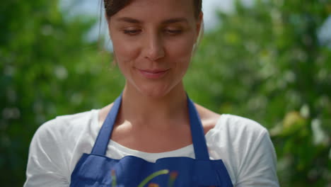 Woman-farmer-showing-cherry-fruit-in-hand-at-local-business-small-farm-market.