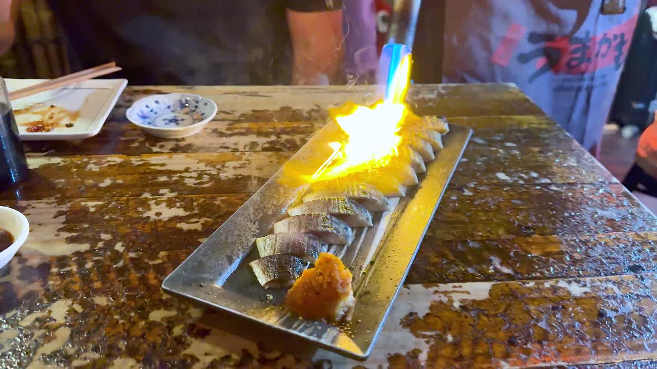 Chef torches sushi for enhanced flavor and presentation
