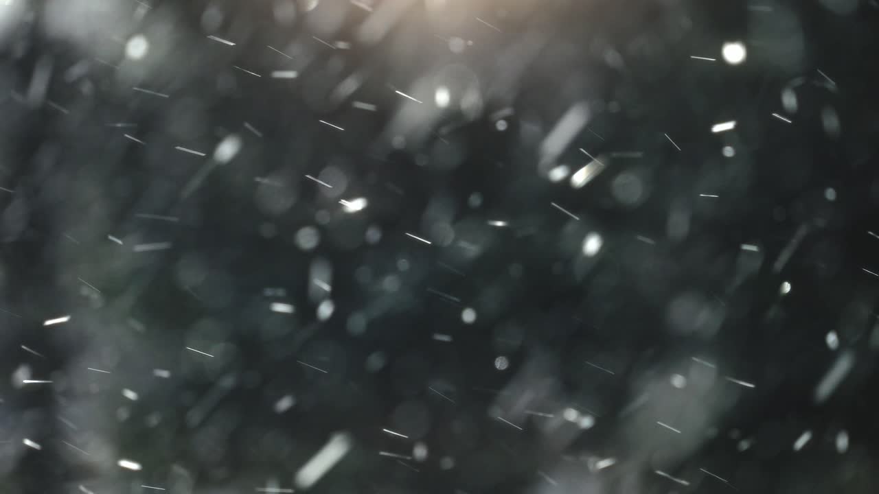 Abstrakte, fallende Schneepartikel mit Bokeh-Hintergrund