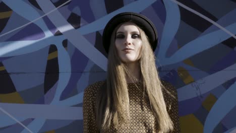 woman in front of a graffiti wall