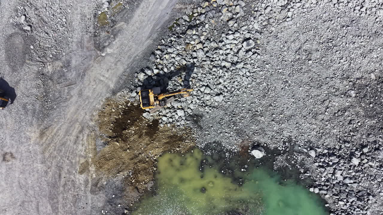 Granite quarry site with heavy machinery working during daytime
