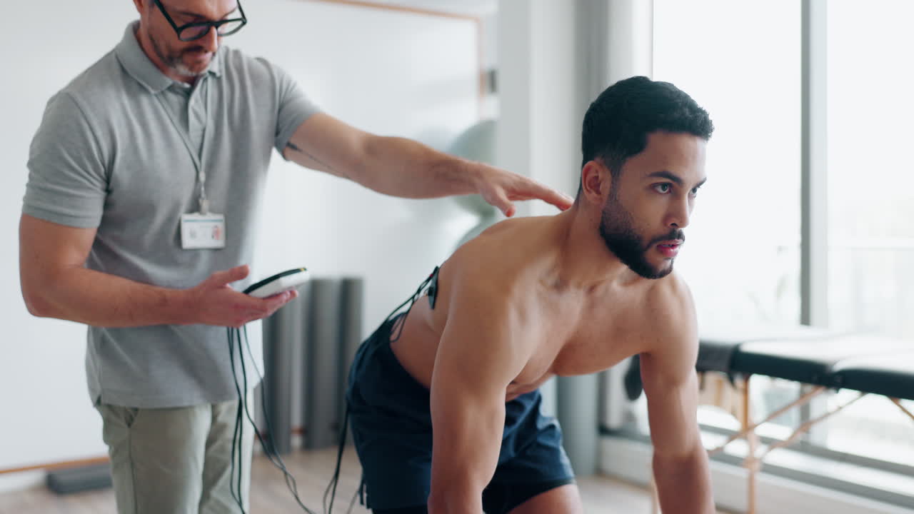 Man with electrical muscle stimulator