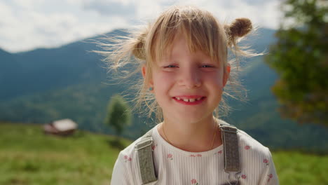 Closeup-happy-girl-face-smiling-on-camera-sunny-day.-Portrait-of-little-lady.