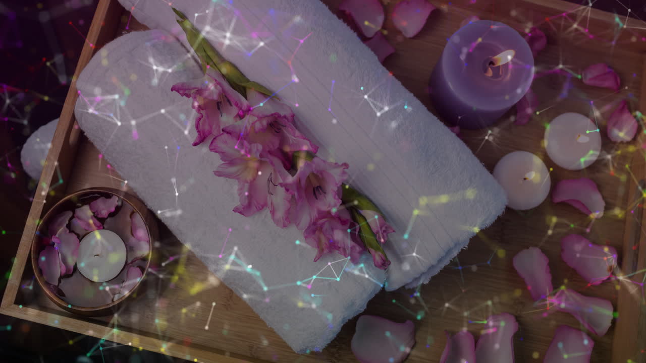 Spa showing rolled white towel resting under pink gladiolus with petals floating around flat design