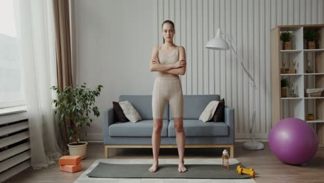 woman practicing yoga in her living room