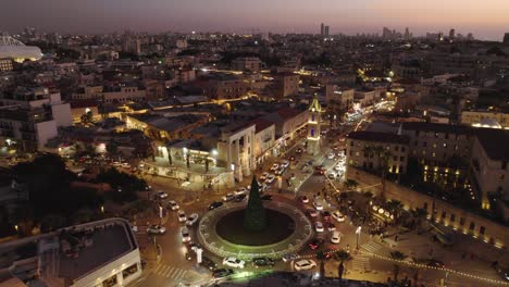 night parallax drone shot over the christmas tree in jaffa tel aviv at sunset - still under construction #011