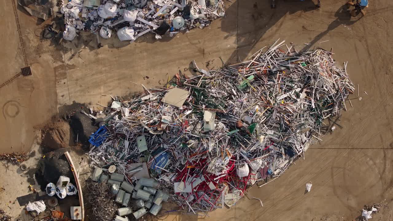 Aerial panorama of a junkyard filled with industrial metal waste
