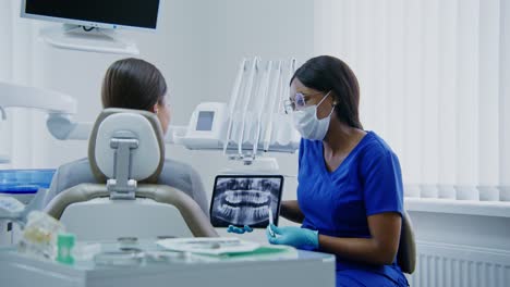 dentist examining x-ray with patient