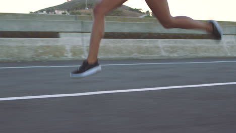 woman running on a city bridge