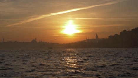 sunset between galata tower and a mosque