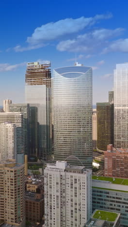amazing chicago architecture in the bright light of morning sun. drone rising over the wonderful city. blue sky with clouds at backdrop. vertical video