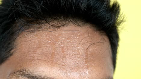 person's forehead with sweat