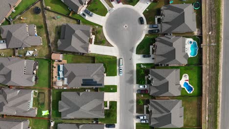 antena de arriba hacia abajo de los tejados de las casas y piscinas en la moderna comunidad suburbana residencial estadounidense