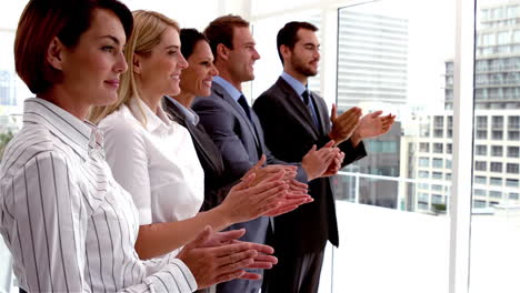 team of business people clapping in a row