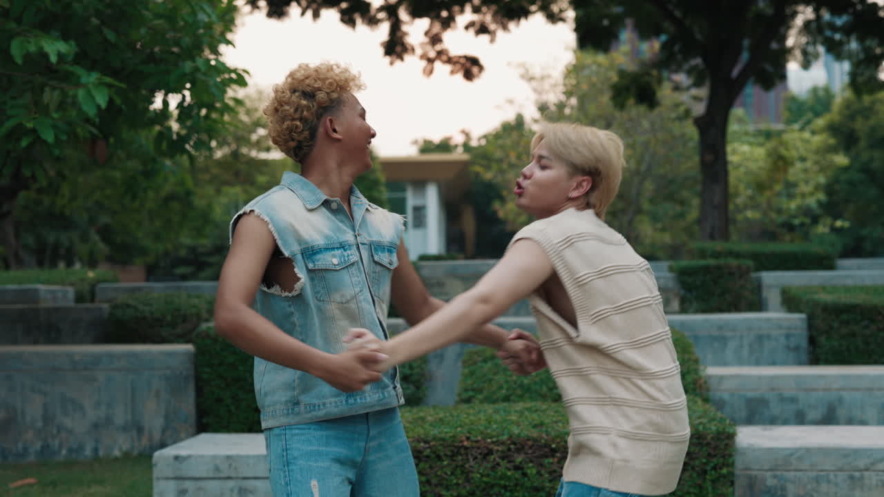 Two Young Men Holding Hands in a Park