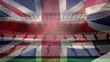 British-flag-floating-with-a-stadium-background