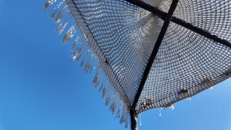Sunbed umbrella luxury beach resort Ksamil Albania, clear blue sky summer season relaxation