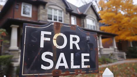 for sale sign in front of house