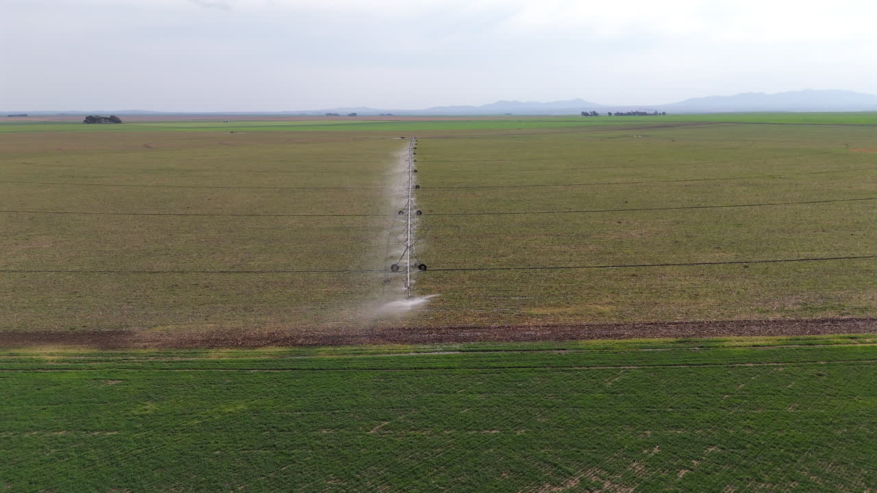 Drone view of vast rural agricultural landscape with automatic irrigation system. 4k.