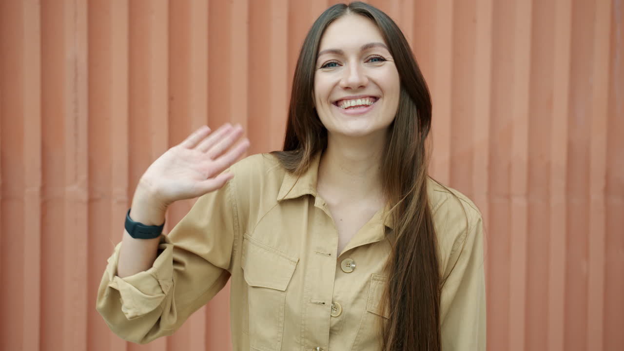 una mujer saludando.