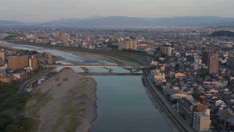 Gifu-city,-sunrise-on-the-Nagaragawa-river-Aerial-view