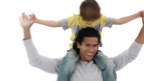 close up of dad giving son piggyback ride