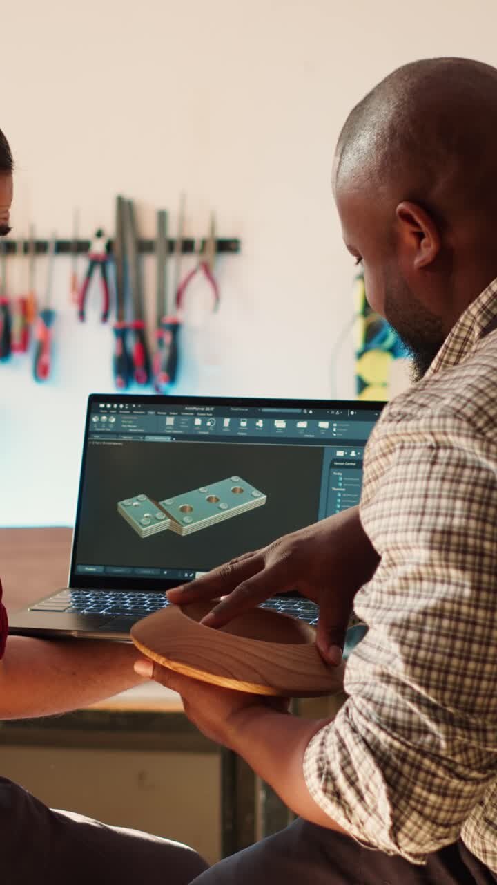 Craftsmen Discussing 3D Design on Laptop in Woodworking Workshop