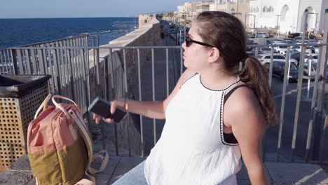 young woman using smartphone in acre, israel