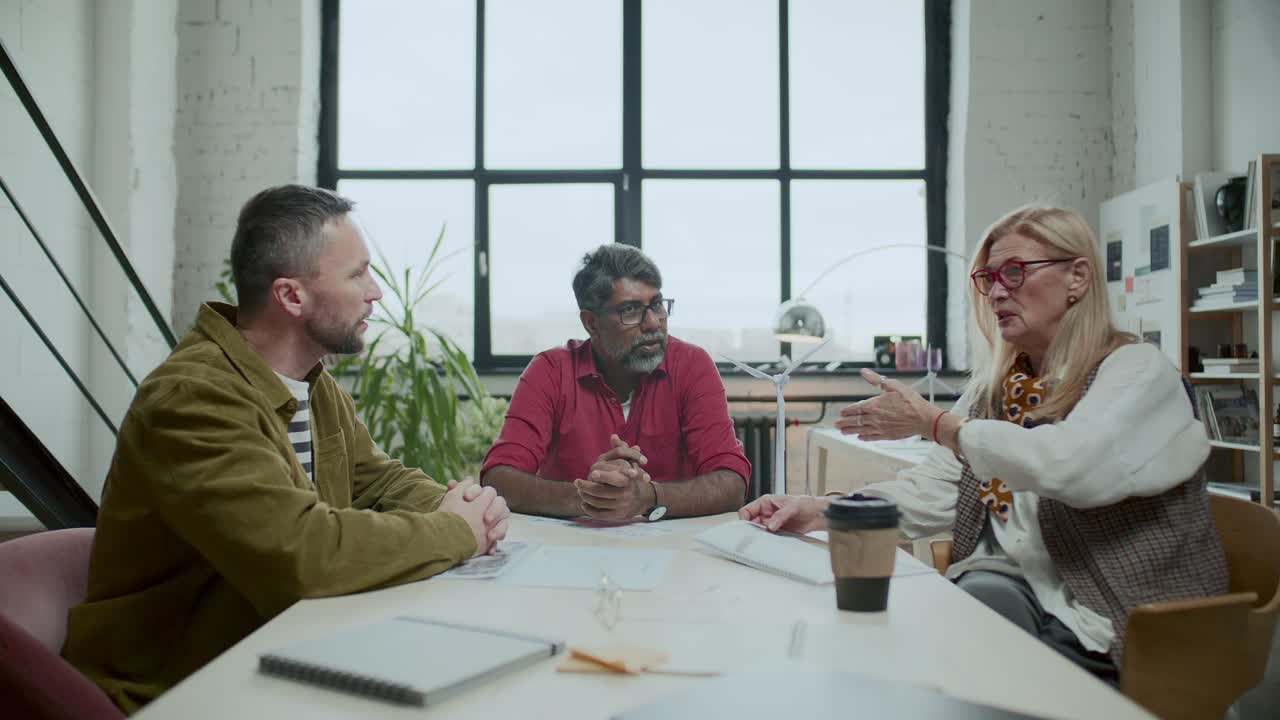 Team of Sustainable Energy Engineers Having Discussion in Office