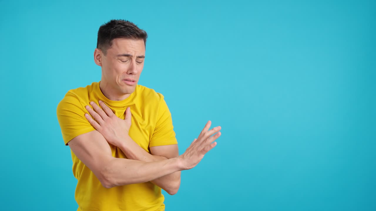 Man crying in yellow shirt