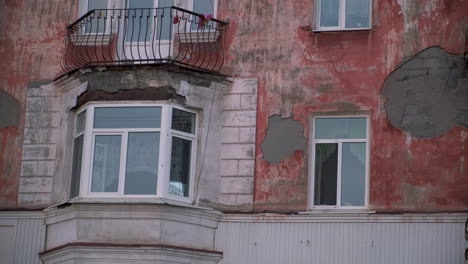 old building facade with deteriorated paint and balconies