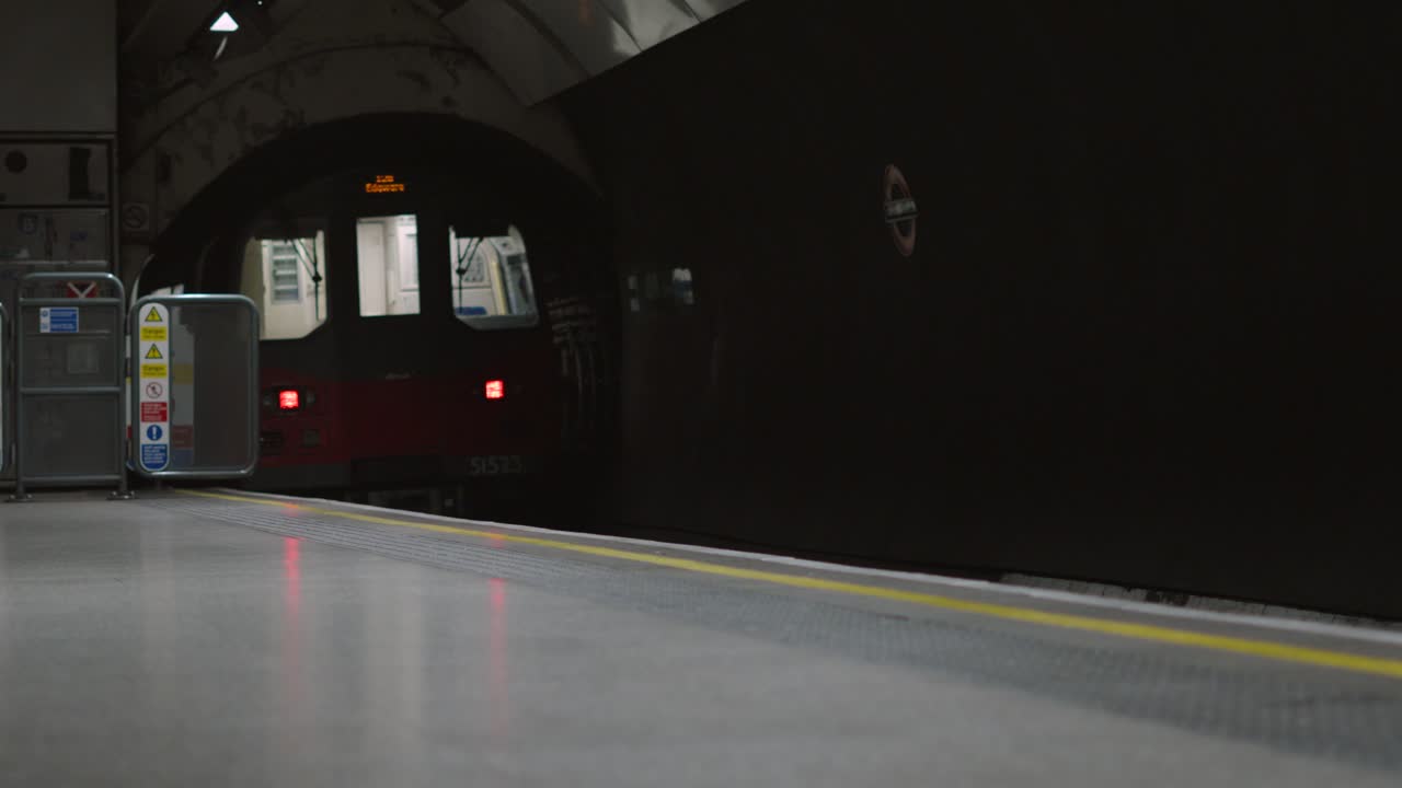 London Tube Disappearing into Dark Subway Underground Tunnel with Rear Lights. City Public Transport