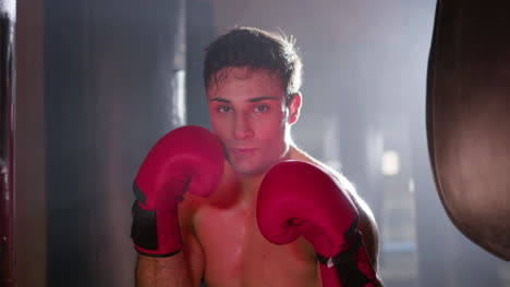 Portrait-shot-of-young-male-boxer-posing-in-fighting-stance