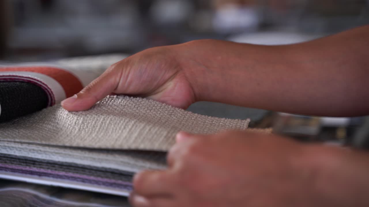 A person feels snippets of fabric