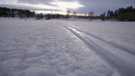 Fresh-trail-lines-carved-into-pristine-powder-white-snowy-woodland-landscape-Katinkulta-Vuokatti-Finland