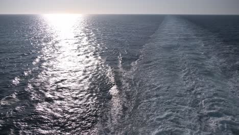 open ocean view from a ship with sunshine and foam waves